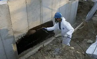 Professional waterproofing the exterior walls of the basement in Fort Wayne, IN