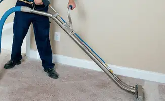 Professional operating a liquid removal machine on a carpeted floor in Fort Wayne, IN